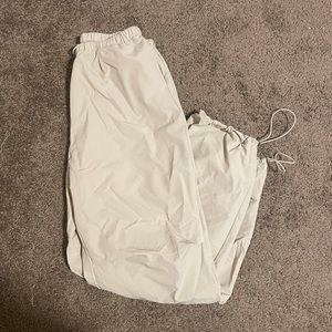 Cream stacked parachute pants with cords